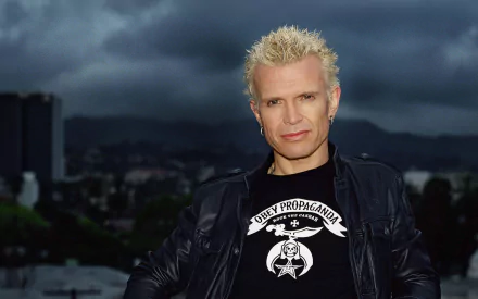 Blond spiky‑haired rock musician and singer in a leather jacket against a stormy city skyline — 2K Quad HD PC desktop wallpaper.