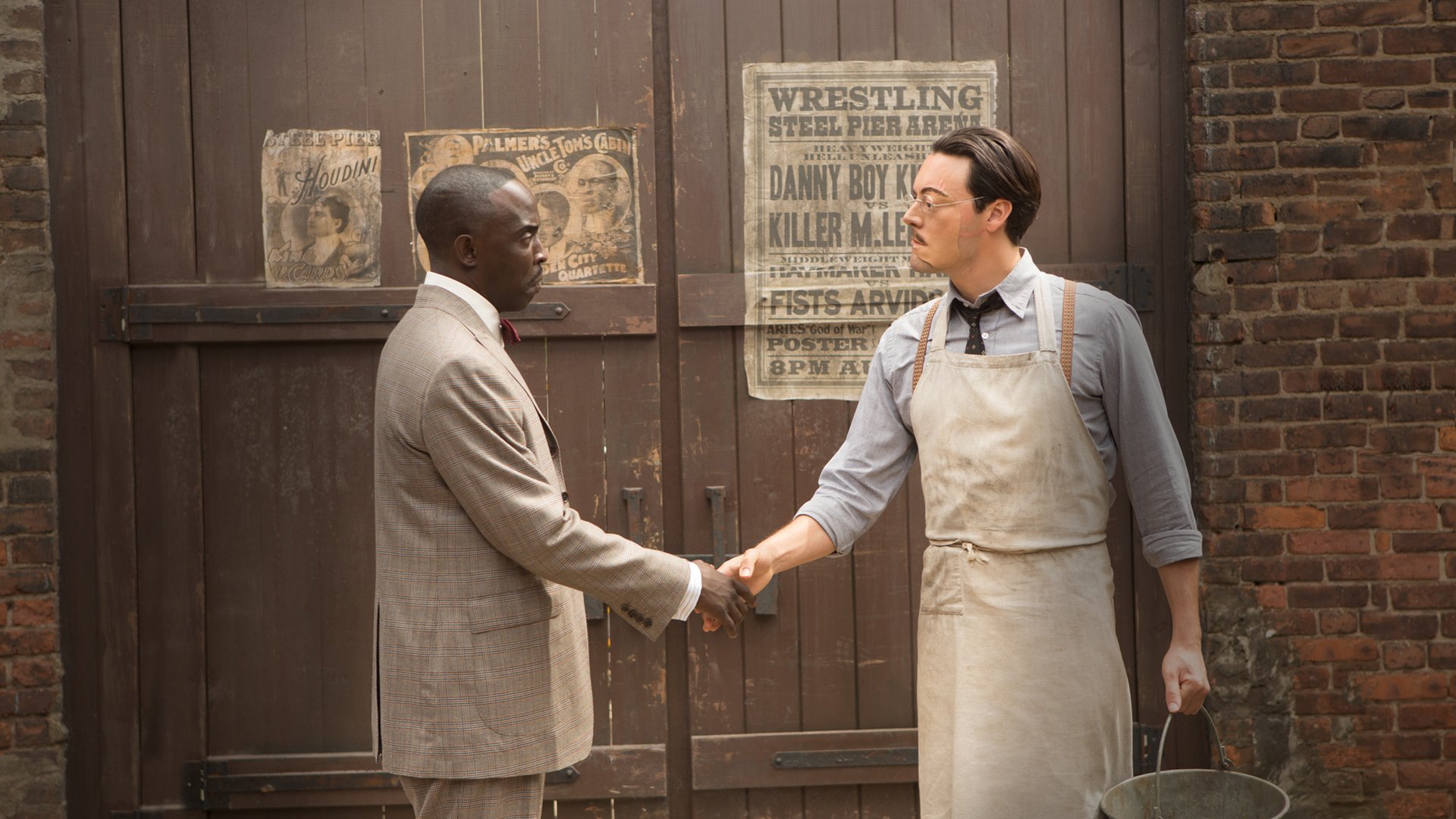 Scene from the TV show Boardwalk Empire showing two men shaking hands in front of a wooden door, featured as an HD PC desktop wallpaper and background.