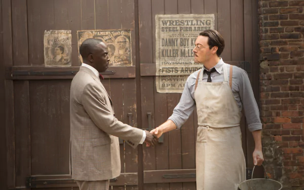 Scene from the TV show Boardwalk Empire showing two men shaking hands in front of a wooden door, featured as an HD PC desktop wallpaper and background.