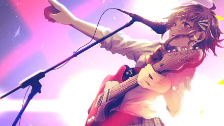 Vibrant HD wallpaper featuring GUMI from Vocaloid, passionately performing with a guitar, set against a dynamic background infused with colorful lights and energy.