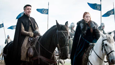 HD desktop wallpaper featuring Petyr Baelish (Aidan Gillen) and Sansa Stark (Sophie Turner) from the TV show Game of Thrones, both mounted on horses with banners in the background.