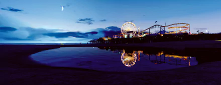 A stunning HD wallpaper from Grand Theft Auto V, depicting a vibrant coastal scene at dusk, featuring a ferris wheel and pier reflected in calm waters under a crescent moon.