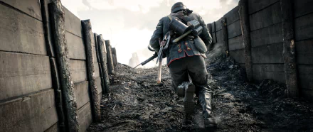 A soldier strides through a muddy trench in Battlefield 1, displaying an intense moment from the game in this high-definition PC desktop wallpaper.