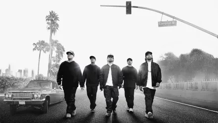 Black and white HD PC desktop wallpaper featuring the cast of the movie Straight Outta Compton walking down a street under a traffic light and palm trees.