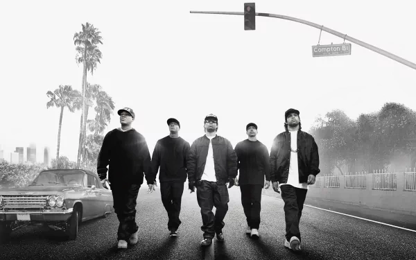 Black and white HD PC desktop wallpaper featuring the cast of the movie Straight Outta Compton walking down a street under a traffic light and palm trees.