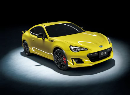 A vibrant yellow Subaru BRZ sports car showcased against a dark background, highlighting its sleek design and dynamic stance, ideally suited as a 4K Ultra HD desktop wallpaper.