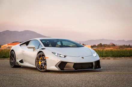 A sleek white Lamborghini Huracan, showcasing its modern design and powerful stance, sits against a picturesque backdrop in this stunning 4K Ultra HD desktop wallpaper.