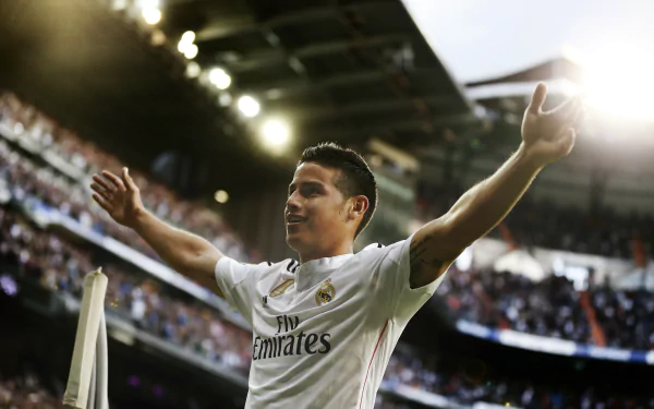 James Rodriguez celebrates on the field while playing for Real Madrid C.F., captured in this dynamic 4K Ultra HD desktop wallpaper. A vibrant moment in sports history.