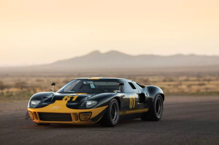 Black Ford GT40 Le Mans supercar with yellow accents, parked on a desert road at sunset, showcased in 4K Ultra HD for PC desktop wallpaper.