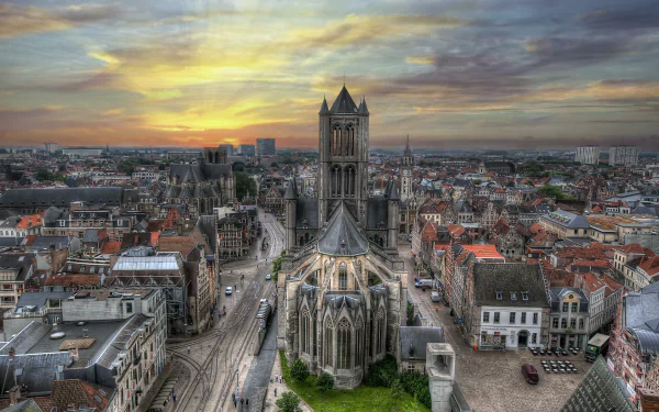 4K Ultra HD panoramic cityscape of Ghent, Belgium, featuring a central Gothic church, historic buildings and cobbled streets — man-made urban architecture for a PC desktop wallpaper background.