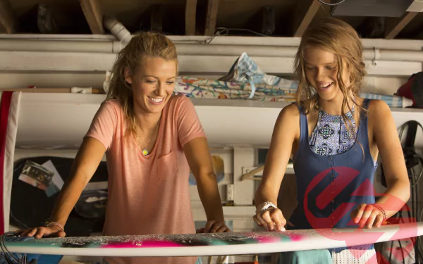 HD PC desktop wallpaper featuring Blake Lively as Nancy from the movie The Shallows, smiling and preparing a surfboard in a bright, casual setting.