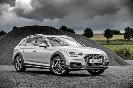 Silver Audi A4 Allroad parked on gravel under dramatic clouds — a sleek Audi vehicle rendered as a 4K Ultra HD PC desktop wallpaper and background.