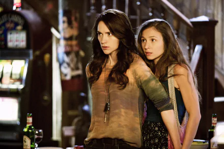 HD desktop wallpaper featuring Dominique Provost-Chalkley and Melanie Scrofano as Waverly Earp in the TV show Wynonna Earp, captured in a tense moment.