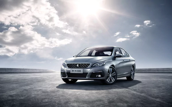 Silver Peugeot 308 sedan showcased under a bright sky on an open surface, captured in stunning 4K Ultra HD as a sleek vehicle desktop wallpaper.