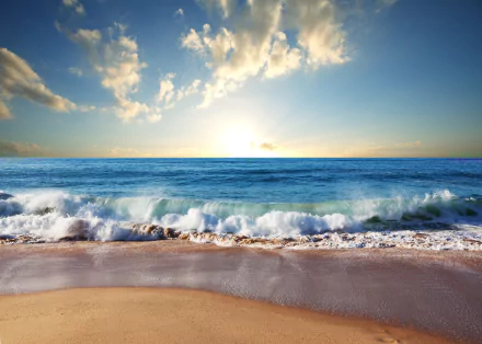HD PC Desktop Wallpaper and Background - serene nature beach at sunrise, gentle waves lapping a sandy shore beneath a blue sky dotted with clouds.