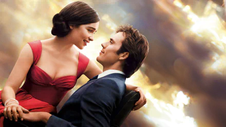 A romantic scene from the movie Me Before You, featuring Emilia Clarke and Sam Claflin. The backdrop showcases a beautiful, dramatic sky, enhancing the emotional connection between the characters.
