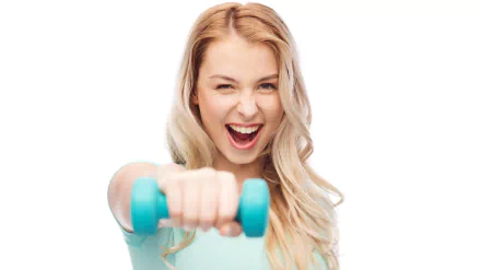 A smiling blonde woman in a fitness outfit holds a blue dumbbell, exuding energy and enthusiasm. This 4K Ultra HD wallpaper captures her sporty spirit.