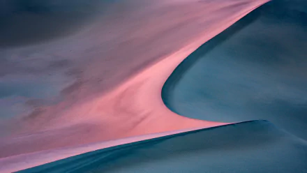 HD PC desktop wallpaper featuring smooth sand dunes in a desert landscape, showcasing soft natural curves and contrasting hues of pink and blue.