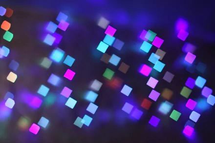 Abstract image featuring a vibrant mix of colors and glittering light, showcasing a soft blur of multicolored squares. This 4K Ultra HD wallpaper creates a mesmerizing backdrop.
