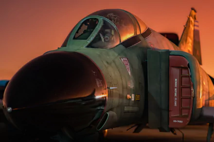 Close-up of a McDonnell Douglas F-4 Phantom II jet fighter warplane at sunset, captured in high definition for a military aircraft desktop wallpaper.