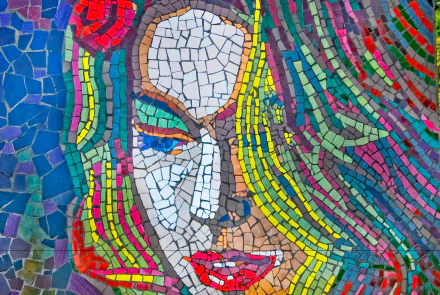 Colorful artistic mosaic of a stylized female face in vibrant tiles, high-definition PC desktop wallpaper and background with flowing multicolored hair and bold geometric features.