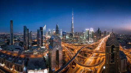 A stunning panorama of Dubai's cityscape at night, showcasing illuminated skyscrapers and bustling highways, highlighting the vibrant energy of the United Arab Emirates.