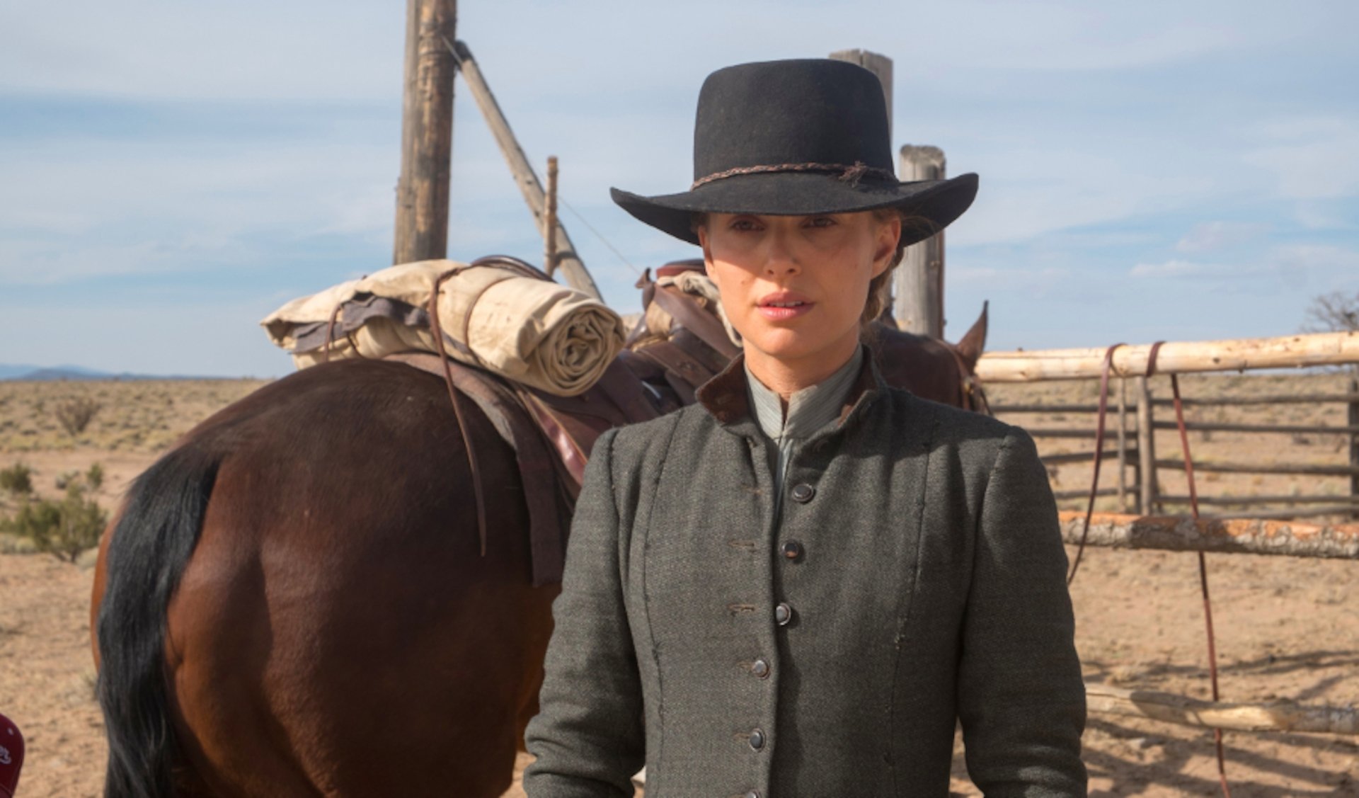 Lead actress in 19th-century western attire and hat standing by a saddled horse — 4K Ultra HD PC desktop wallpaper from the movie Jane Got a Gun.