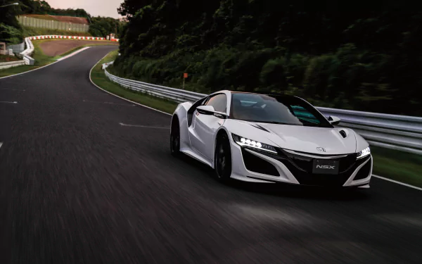 White Honda NSX supercar speeding on a winding racetrack, captured in stunning 4K Ultra HD for a sleek PC desktop wallpaper and background.