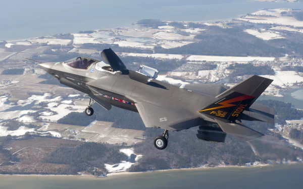 Lockheed Martin F-35 Lightning II jet fighter by Northrop Grumman in flight over snowy terrain, showcasing advanced military aircraft design in HD desktop wallpaper quality.