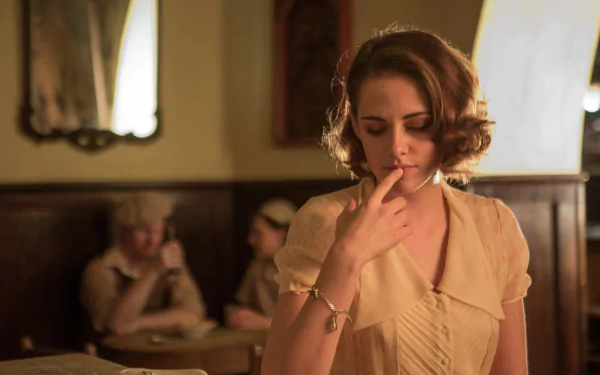 A 4K Ultra HD PC wallpaper from the movie Cafe Society, featuring a woman in vintage attire thoughtfully touching her lips in a dimly lit café setting.