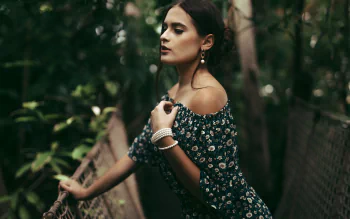 Brunette woman model outdoors in a floral off-shoulder dress, captured in a high-definition PC desktop wallpaper background.