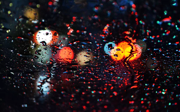 4K Ultra HD desktop wallpaper featuring vibrant bokeh lights blurred through raindrops on glass, creating a colorful and atmospheric photography composition.