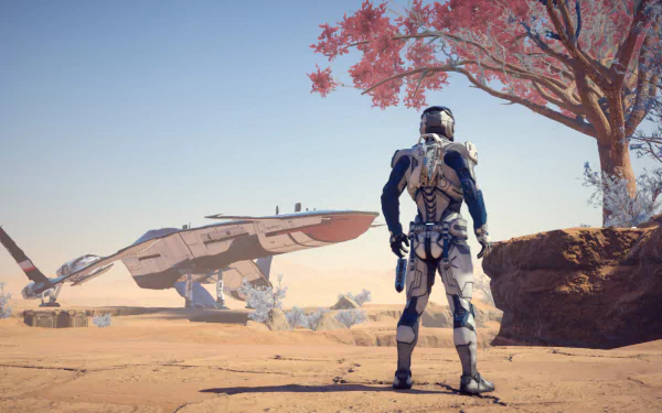 Scott Ryder stands in a vibrant extraterrestrial landscape, gazing at a sleek spaceship in the distance, from the video game Mass Effect: Andromeda. HD PC desktop wallpaper.