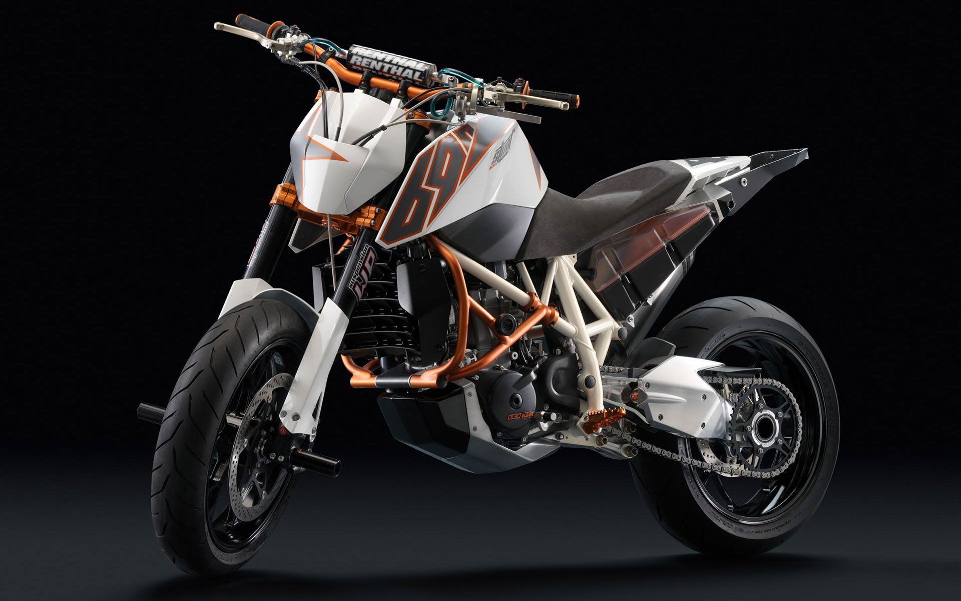 HD PC desktop wallpaper featuring a sleek, modern motorcycle bike with an orange and white frame against a black background.