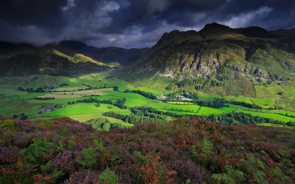 Dramatic 4K Ultra HD landscape of an English valley with lush forests and rugged mountains under a moody sky, showcasing nature’s vivid beauty.