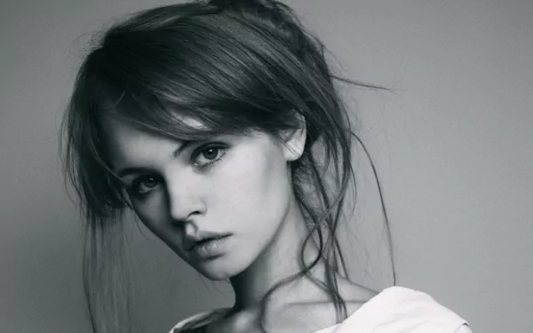 Black and white HD desktop wallpaper featuring a close-up of a Russian model, Anastasiya Scheglova, with a serene expression and tousled hair.