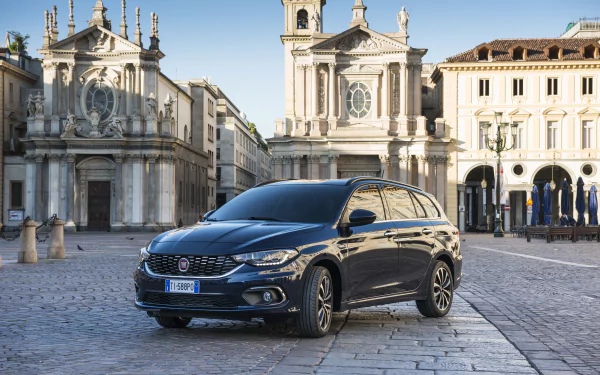 A sleek black Fiat Tipo car parked on a historic city square with classic European architecture in the background, captured in stunning 4K Ultra HD detail.