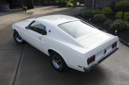 1969 white Ford Mustang Boss 429 muscle car parked on a driveway, showcasing its classic design in an HD desktop wallpaper background.