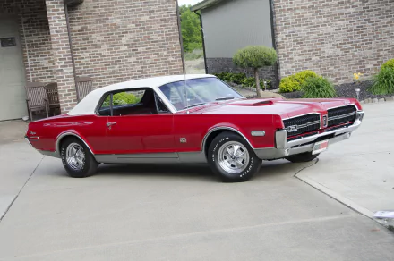 A vibrant red 1968 Mercury Cougar GT-E muscle car parked in a driveway, featured as an HD PC desktop wallpaper and background.