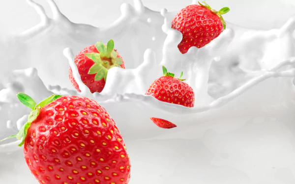 Vibrant strawberries splashing into creamy milk, captured in stunning 8K Ultra HD, creating a fresh and dynamic fruit and food desktop wallpaper.