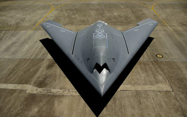 A top view of the Dassault nEUROn, a sleek military drone, showcased on the tarmac. This high-tech warplane emphasizes advanced design and drone technology. 4K Ultra HD wallpaper.