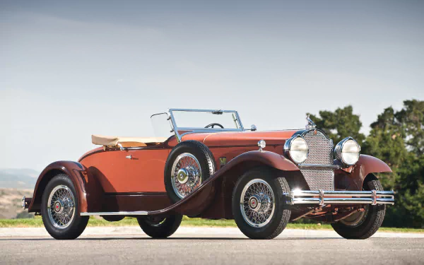 1930 Packard Speedster Eight Boattail Roadster vintage vehicle: red open-top Packard on a sunlit road, presented as an HD PC desktop wallpaper background