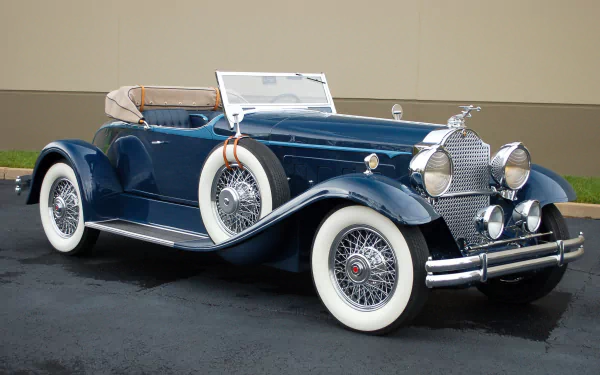 Vintage 1930 Packard Speedster Eight Boattail Roadster in dark blue, showcasing classic design and whitewall tires, featured as an HD PC desktop wallpaper and background.