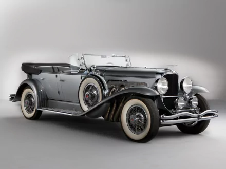 HD desktop wallpaper featuring a sleek vintage 1929 Duesenberg Model J Dual Cowl Phaeton, showcasing classic design and elegance in a stunning vehicle profile.