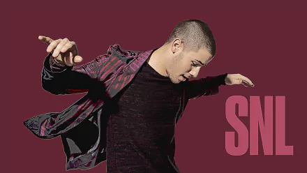 Nick Jonas performing on Saturday Night Live, captured in a dynamic pose against a striking backdrop. This HD wallpaper showcases his vibrant energy and style.