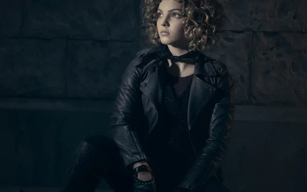 Camren Renee Bicondova as Selina Kyle, also known as Catwoman, poses dramatically in a dark setting from the TV show Gotham. HD wallpaper featuring an iconic character.