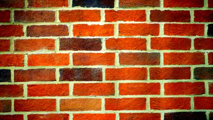 Close-up photography of a textured red brick wall, captured in 4K Ultra HD quality for a detailed PC desktop wallpaper and background.