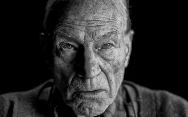 Black and white HD wallpaper featuring Patrick Stewart as Professor X from the movie Logan, showcasing a detailed, emotive close-up of his face.