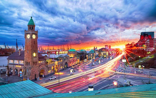 Sunbeam streaks through a time-lapse sunset over Hamburg's iconic architecture and bustling cityscape, showcasing a vibrant man-made urban scene in Germany.