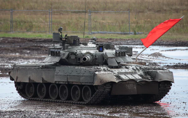 HD PC desktop wallpaper featuring a T-80 military tank positioned on muddy terrain with a red flag attached.
